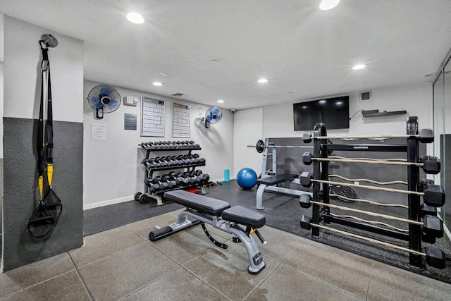 exercise room featuring a textured ceiling