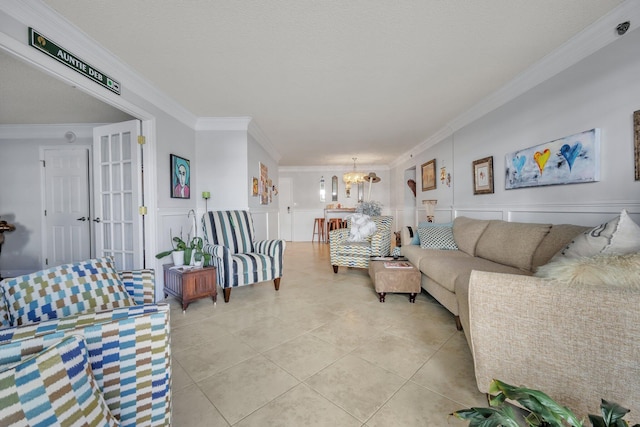 living room with a notable chandelier, light tile patterned flooring, and crown molding