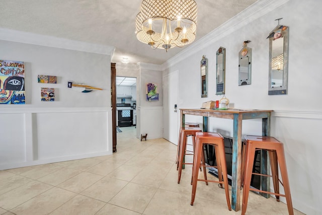 tiled dining room with ornamental molding, a textured ceiling, and an inviting chandelier