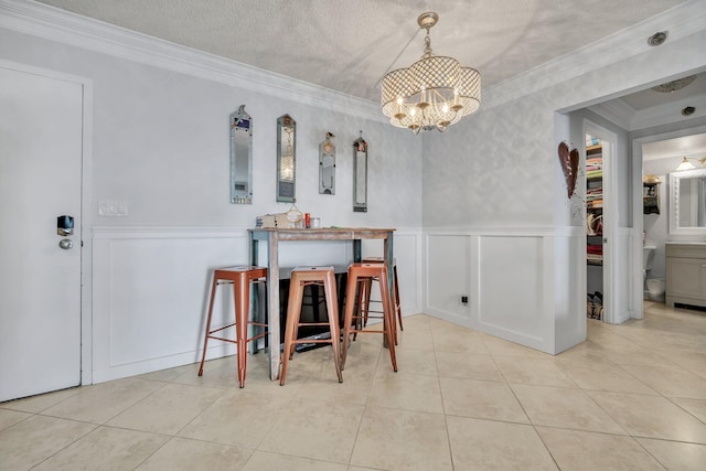 tiled dining area with crown molding, a chandelier, and a textured ceiling