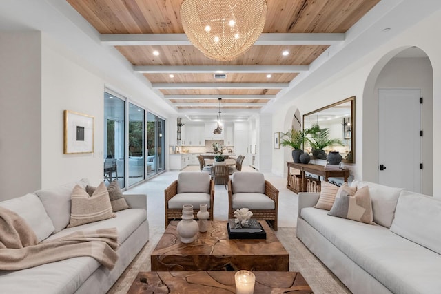 carpeted living room featuring beamed ceiling and wooden ceiling