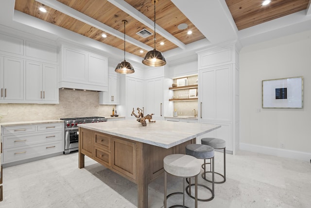 kitchen featuring white cabinets, a center island, high end stainless steel range, and wood ceiling