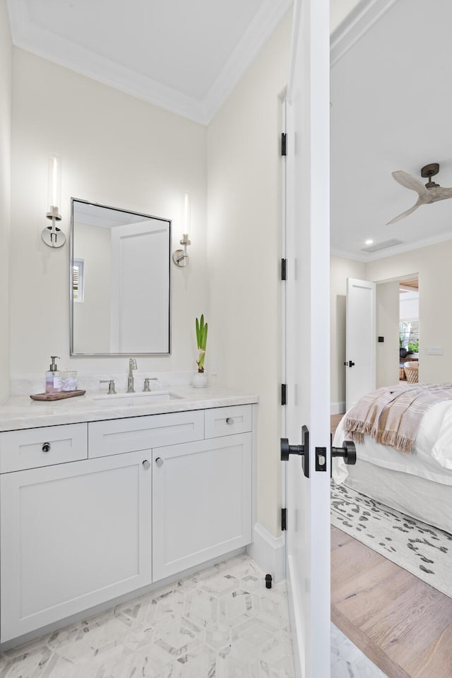 bathroom with hardwood / wood-style floors, ceiling fan, crown molding, and vanity