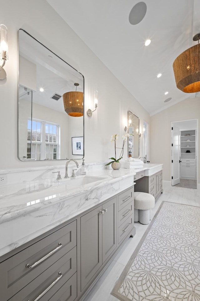 bathroom with vanity, tile patterned floors, and lofted ceiling