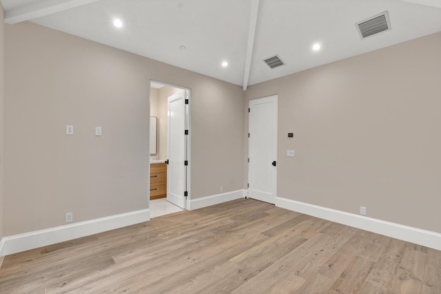 unfurnished room with lofted ceiling with beams and light hardwood / wood-style floors