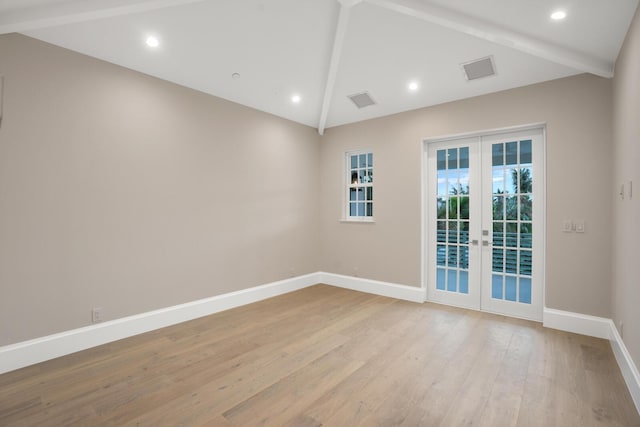 unfurnished room with vaulted ceiling with beams, french doors, and light hardwood / wood-style floors