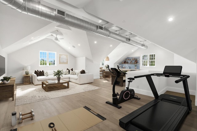 exercise area with hardwood / wood-style floors, ceiling fan, a wealth of natural light, and vaulted ceiling