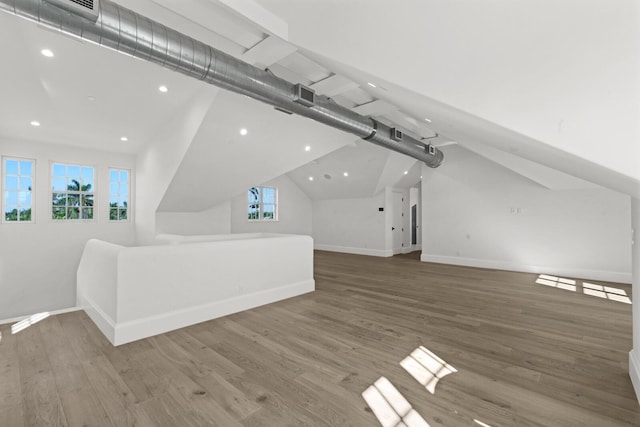 bonus room with hardwood / wood-style floors and lofted ceiling