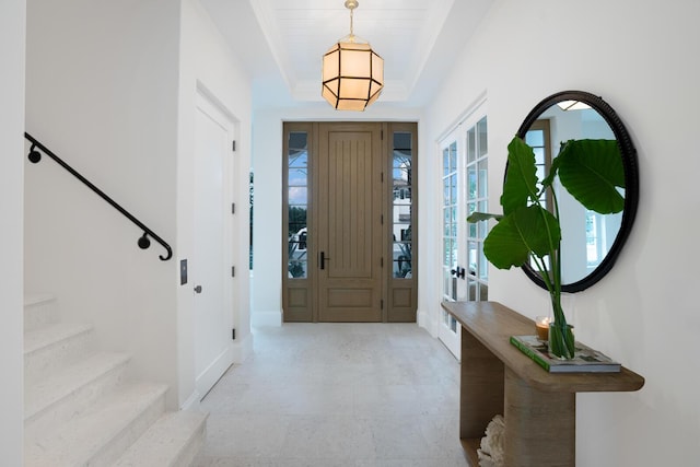 entryway featuring french doors and a raised ceiling