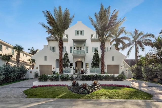 1114 N Vista Del Mar Dr, Delray Beach, FL 33483 - view of front of house with stucco siding, decorative driveway, and an attached garage
