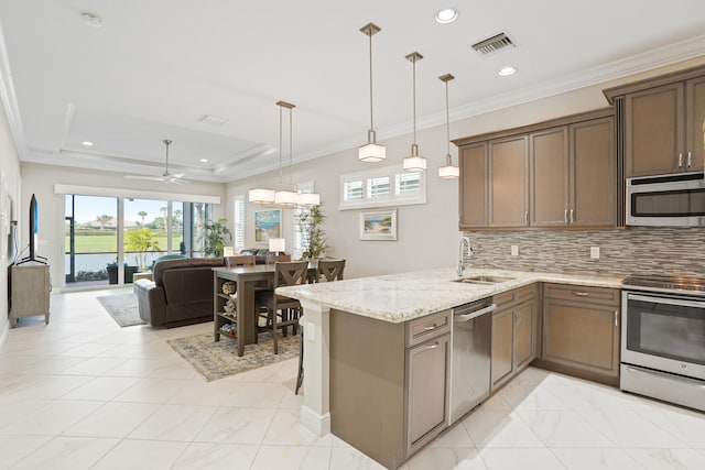 kitchen with kitchen peninsula, tasteful backsplash, stainless steel appliances, ceiling fan, and pendant lighting