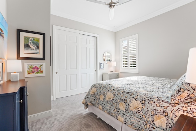 bedroom featuring crown molding, ceiling fan, a closet, and light carpet