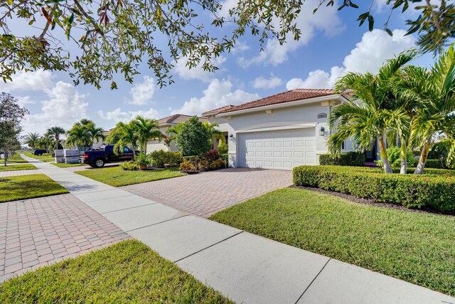 view of front of property with a front lawn and a garage