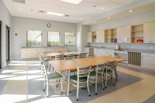 dining area featuring a drop ceiling and sink