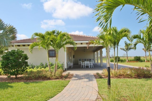 exterior space with a lawn and a patio