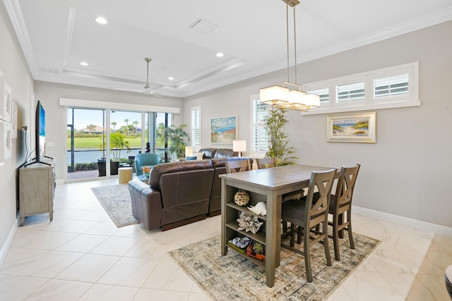 dining area with ceiling fan, crown molding, and a tray ceiling