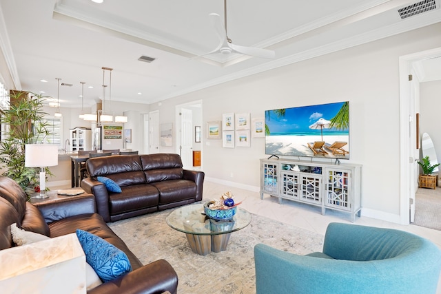 living room featuring ceiling fan, ornamental molding, sink, and light tile patterned floors