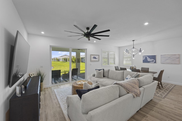 living room with an inviting chandelier and light hardwood / wood-style floors