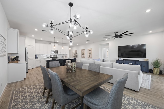 dining space with light hardwood / wood-style floors