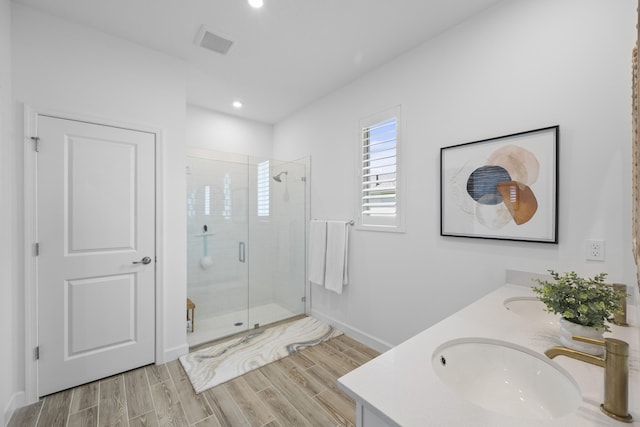 bathroom with vanity and a shower with shower door