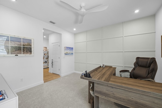 office space with light colored carpet and ceiling fan