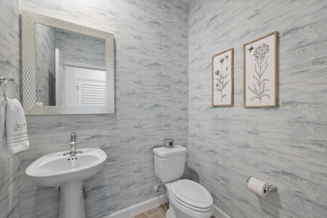 bathroom with wood-type flooring and toilet