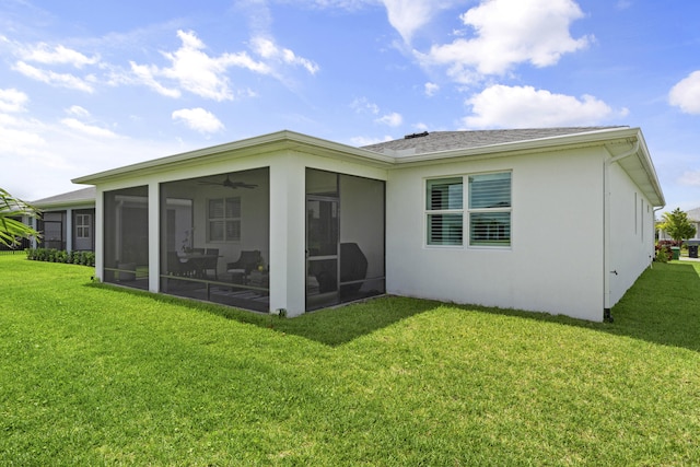 back of house with a sunroom and a lawn