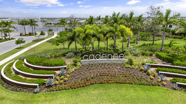 view of community with a lawn and a water view