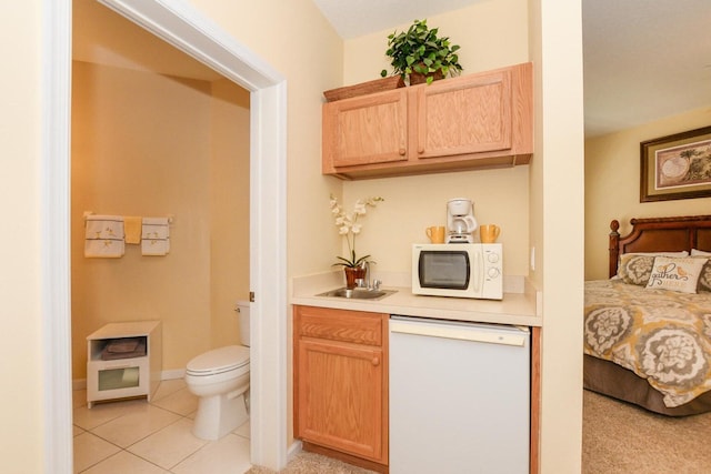 interior space featuring sink, tile patterned flooring, and toilet