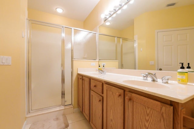 bathroom with tile patterned floors, vanity, and an enclosed shower