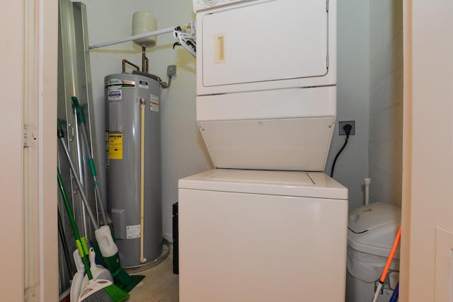 washroom featuring electric water heater and stacked washer and dryer