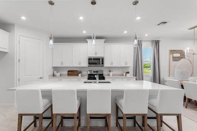 kitchen with visible vents, recessed lighting, marble finish floor, stainless steel appliances, and a sink