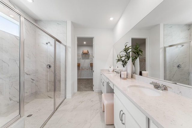 bathroom featuring a marble finish shower, marble finish floor, double vanity, and a sink