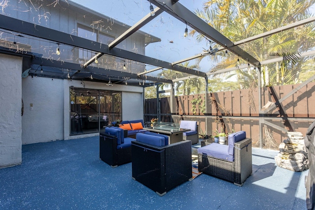 view of patio / terrace with an outdoor living space and glass enclosure