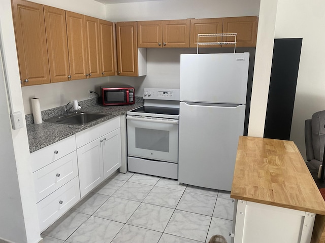 kitchen with white appliances, wooden counters, white cabinets, sink, and light tile patterned flooring