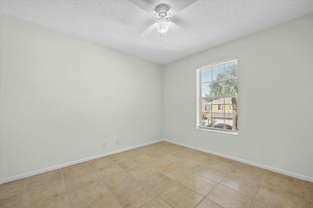 tiled spare room with a textured ceiling and ceiling fan