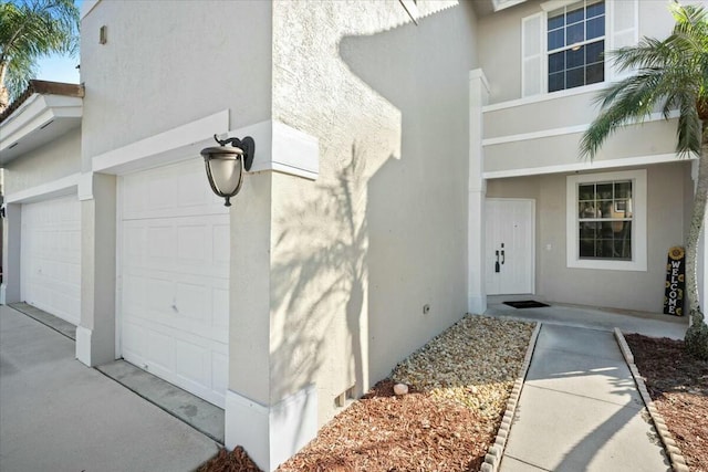 view of exterior entry with a garage