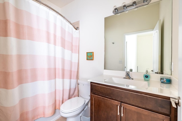 bathroom with vanity, curtained shower, and toilet