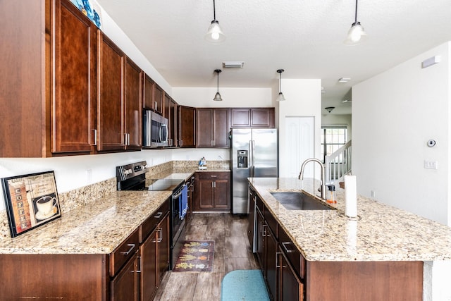 kitchen featuring decorative light fixtures, stainless steel appliances, dark wood-type flooring, and sink