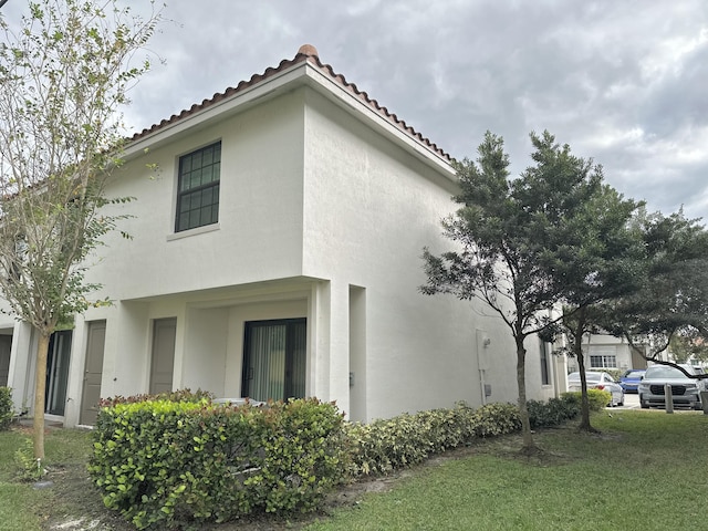 view of side of home with a lawn