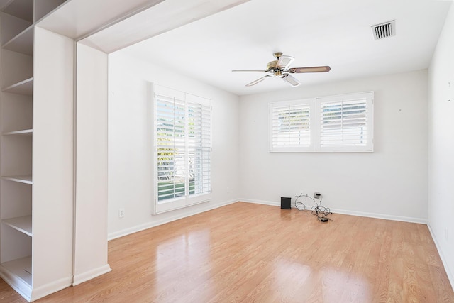 spare room featuring ceiling fan, plenty of natural light, and light hardwood / wood-style floors