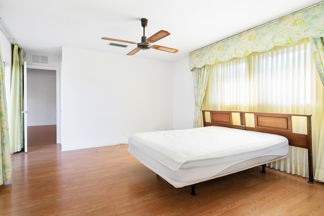 bedroom with hardwood / wood-style floors and ceiling fan