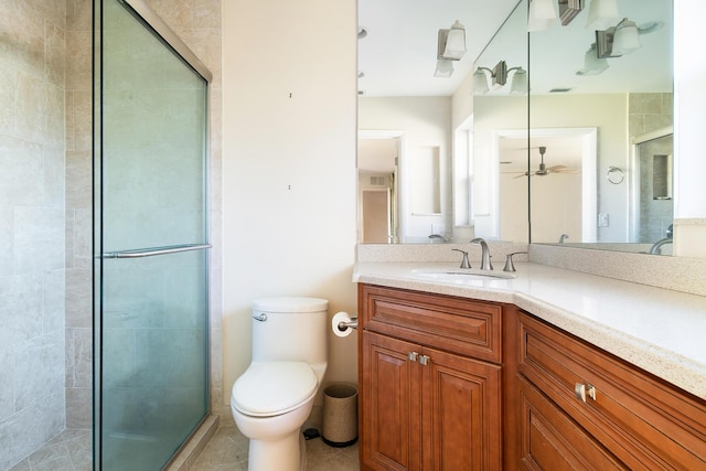 bathroom featuring vanity, tile patterned flooring, a shower with shower door, and toilet