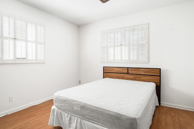 bedroom with hardwood / wood-style floors