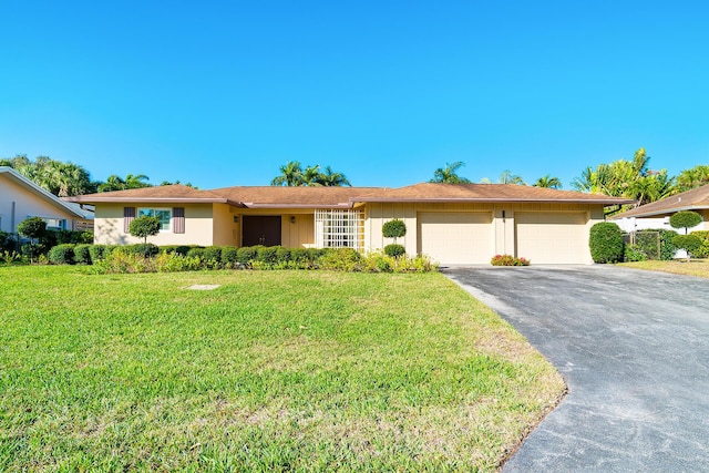 ranch-style home featuring a garage and a front lawn