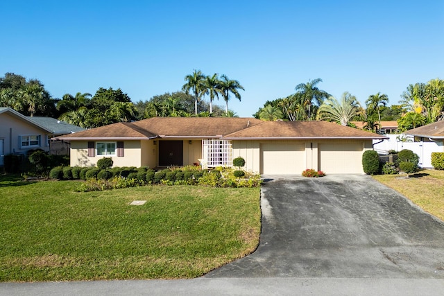 single story home with a garage and a front lawn