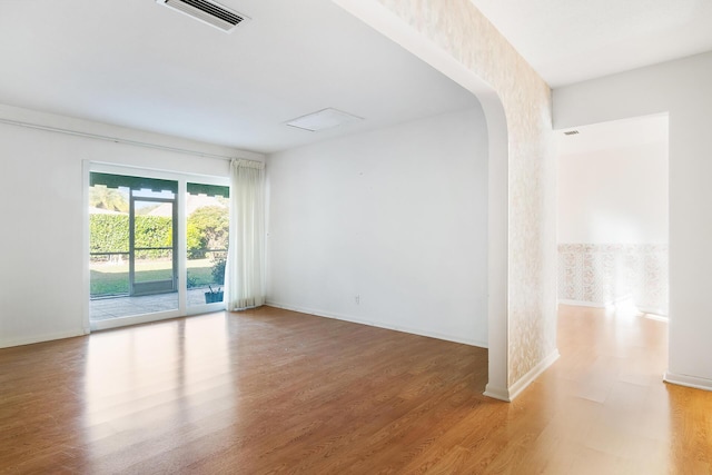 empty room with hardwood / wood-style flooring