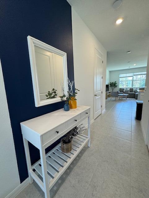 hallway featuring light tile patterned flooring