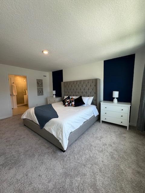 bedroom featuring carpet and a textured ceiling