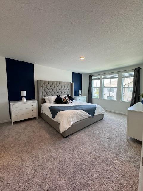 carpeted bedroom with a textured ceiling